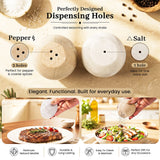 A marble seasoning and salt shaker set. The top half shows two white natural marble shakers with labeled dispensing holes for pepper and salt, with inset photos of spices and salt.