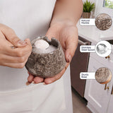 Person holding a small decorative pot with natural marble finish, stainless steel spoon, and sturdier base.