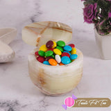 Marble-textured container filled with colorful candies on a marble surface, with 'Treats Fit Too' logo.