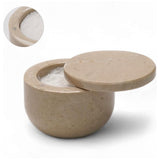 Beige stone salt container with lid on a white background