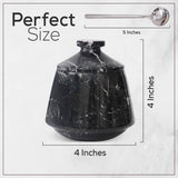 Black marble jar with spoon and size measurements on a white background