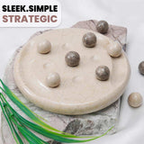 Round stone surface with round balls on a textured surface, featuring the text 'Sleek.Simple.Strategic'.