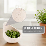 White marble 3 peeler with green herbs on a wooden surface, featuring a 3-hole design.